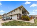 Multi-Gathering home shows the garage, front yard and a silver vehicle parked in the driveway at 9868 Appletree Pl, Thornton, CO 80260