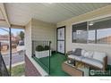 Relaxing outdoor patio area featuring comfortable seating and a view of the neighborhood at 9868 Appletree Pl, Thornton, CO 80260