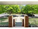 A glimpse from the porch steps of a tree-lined street and a welcoming walkway at 101 Se 2Nd St, Berthoud, CO 80513