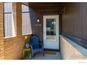 Cozy front porch with a blue chair and brick accents at 1215 Centaur Cir # A, Lafayette, CO 80026