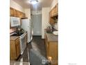 Efficient kitchen with updated appliances, neutral countertops, and convenient access to the exterior at 1215 Centaur Cir # A, Lafayette, CO 80026