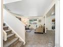 Inviting living room with a staircase, comfortable seating, and a neutral color palette at 1215 Centaur Cir # A, Lafayette, CO 80026