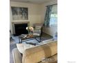 Cozy living room with fireplace, comfortable seating, and a decorative pillow that says 'Colorado' at 1215 Centaur Cir # A, Lafayette, CO 80026