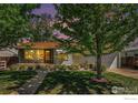 Charming home featuring stone accents, a well-manicured lawn, and mature trees at 1275 Walnut St, Brighton, CO 80601