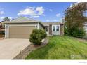 Inviting home with a well-maintained lawn, attached garage and attractive curb appeal at 1512 Calkins Ave, Longmont, CO 80501