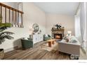 Cozy living room with hardwood floors, fireplace, and ample seating at 1512 Calkins Ave, Longmont, CO 80501