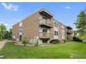 Attractive apartment building featuring balconies, well-maintained landscaping, and a lush lawn at 1606 Cottonwood Dr # 16S, Louisville, CO 80027