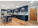 Spacious kitchen featuring blue cabinets, stainless steel appliances, and an island with seating at 1606 Cottonwood Dr # 16S, Louisville, CO 80027