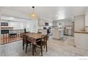 Open concept dining room with kitchen island, stainless steel appliances, and ample seating at 1610 Vivian St, Longmont, CO 80501