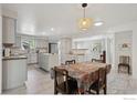 Open concept dining room with kitchen island, stainless steel appliances, and ample seating at 1610 Vivian St, Longmont, CO 80501