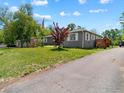 A cozy single-story home with a well-maintained lawn and an American flag at 1815 9Th Ave, Longmont, CO 80501