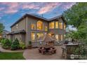 Charming patio with stone benches and seating area, perfect for outdoor entertaining with large windows at 19061 Eagle Ridge Dr, Golden, CO 80401