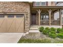 Close up shot of a lovely porch, front door, and stone facade at 2165 Summerlin Ln, Longmont, CO 80503