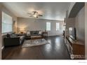 Spacious living room with hardwood floors, a ceiling fan, and plenty of natural light at 2190 Winding Dr, Longmont, CO 80504