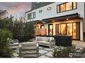 Charming backyard patio with modern outdoor furniture, privacy landscaping, and stylish pavers at 2248 S Lincoln St, Denver, CO 80210