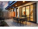 Outdoor patio features a dining set, modern pavers, and access to the home through sliding glass doors at 2248 S Lincoln St, Denver, CO 80210