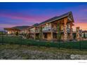 Stunning multi-level home with stone and wood accents, balconies, and a beautifully landscaped yard at 2387 Harding Park Ct, Berthoud, CO 80513