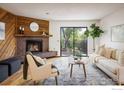 Inviting living room features a brick fireplace, wood accents, and a sliding glass door to the yard at 2725 Juniper Ave # 78, Boulder, CO 80304
