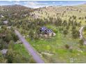 A home nestled on a picturesque hillside offering privacy and stunning views of nature at 3021 N Lakeridge Trl, Boulder, CO 80302