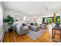 Spacious living room with hardwood floors, a large gray sofa, and lots of natural light at 325 Colgate St, Boulder, CO 80305