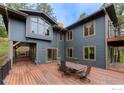 Expansive back deck with outdoor dining set, ideal for gatherings and relaxation at 335 Pine Tree Ln, Boulder, CO 80304