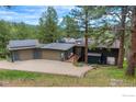 Spacious home with a three car garage, solar panels, and well manicured lawn at 335 Pine Tree Ln, Boulder, CO 80304