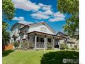 A charming home featuring a covered porch, manicured lawn, and inviting curb appeal at 395 Longspur Dr, Brighton, CO 80601