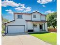 Spacious home featuring a two-car garage and well-manicured lawn for a welcoming exterior at 395 Longspur Dr, Brighton, CO 80601