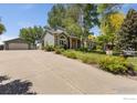 Inviting home with a spacious driveway and lush landscaping, offering ample parking and curb appeal at 531 S 9Th St, Berthoud, CO 80513