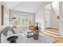 Open living room with a large window, comfortable seating, and a view of the entryway at 5348 Wild Dunes Ct, Boulder, CO 80301