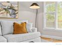 Cozy living room corner featuring a comfortable couch with a decorative pillow and window with blinds at 5348 Wild Dunes Ct, Boulder, CO 80301