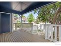 Inviting covered front porch with white railings, providing a charming outdoor space at 911 Homer Cir, Lafayette, CO 80026