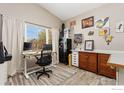 Functional office space with a large window, desk, and ample storage for a productive workspace at 10278 Dover St, Firestone, CO 80504