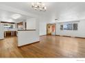 Inviting living room with beautiful hardwood floors, an open layout, and natural light at 1229 Juniper St, Longmont, CO 80501