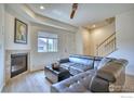 Inviting living room featuring a cozy fireplace and a stylish leather sectional sofa at 1240 Wren Ct # B, Longmont, CO 80501