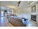 Bright open-concept living room with a fireplace, flowing into the dining and kitchen areas at 1240 Wren Ct # B, Longmont, CO 80501