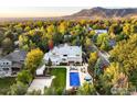 Expansive aerial view of the property showcasing its landscaping, pool, and surrounding neighborhood in autumn at 1505 Oak Ave, Boulder, CO 80304