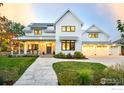 Beautiful two-story home featuring a manicured lawn, stone walkway, inviting front porch, and three-car garage at 1505 Oak Ave, Boulder, CO 80304