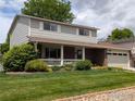 Lovely two-story home with a cozy front porch and a lush green lawn at 1545 S Vivian St, Longmont, CO 80501
