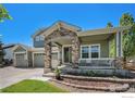 Charming home with stone accents on the porch and garage, plus professionally landscaped front yard at 15562 E 109Th Ave, Commerce City, CO 80022