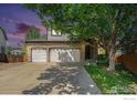Charming two-story home with a brick facade, three-car garage, and a well-maintained lawn and landscaping at 1638 E 131St Cir, Thornton, CO 80241
