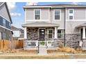 Charming two-story home with a stone facade and inviting front porch at 21823 E 8Th Ave, Aurora, CO 80018