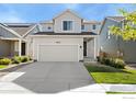 Charming two-story home with a two-car garage, landscaped yard, and welcoming front porch at 2672 Prairiestar Dr, Berthoud, CO 80513