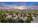 Picturesque aerial view of a suburban neighborhood surrounded by rolling hills and a stunning mountain range at 2841 Silver Pl, Superior, CO 80027