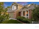 Close up of a charming two-story home with brick accents, bay window, and manicured lawn at 2841 Silver Pl, Superior, CO 80027