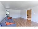 Spacious living room featuring hardwood floors, a comfortable sofa, and neutral walls at 3375 Zephyr Ct, Wheat Ridge, CO 80033