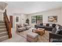 Inviting living room featuring large windows for natural light, neutral carpet, and a cozy seating area at 4116 W 111Th Cir, Westminster, CO 80031