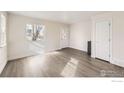 Bright living room featuring wood floors, a large window, and modern finishes at 4529 Barnacle Ct, Boulder, CO 80301