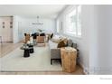 Bright living room featuring a comfortable sofa, stylish decor, and ample natural light at 4601 S Lipan St, Englewood, CO 80110