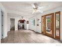 Open layout with tile floors, view of the kitchen, and large double doors at 529 Main St, Louisville, CO 80027
